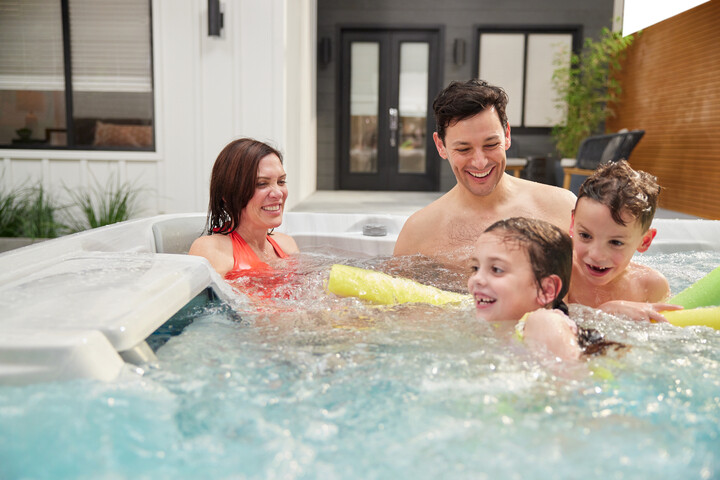 hot tub buying guide - family playing in a hot tub