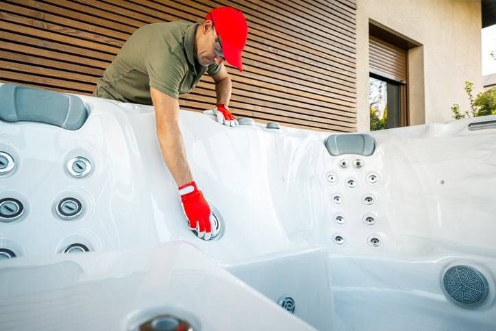 a hot tub technician performing a hot tub maintenance